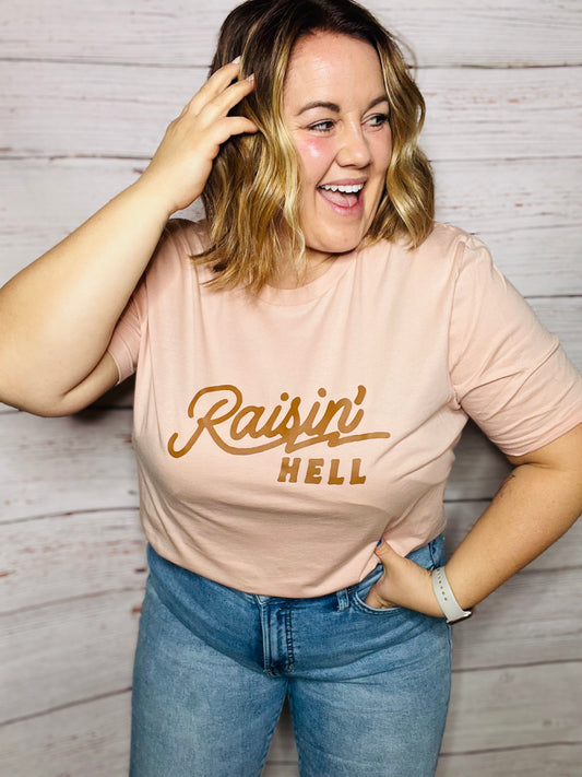 RAISIN' HELL (BROWN INK) Unisex T-shirt in PEACH